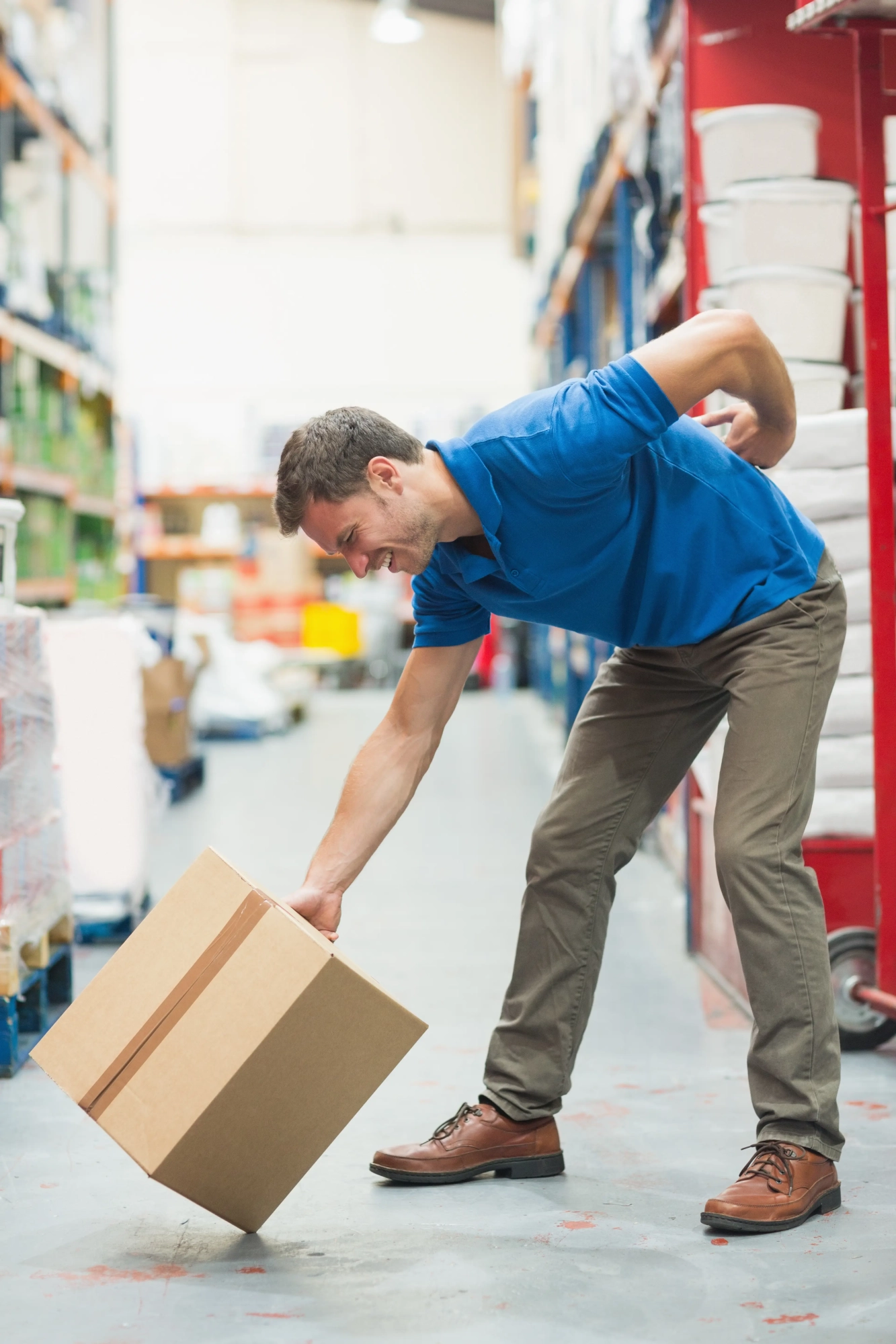 worker-with-backache-while-lifting-box-warehouse